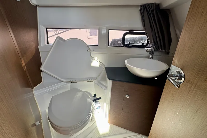 Shanty Town Yacht Photos Pics 2020 Jeanneau NC 895 boat bathroom with toilet, sink, and window.