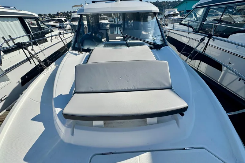 Shanty Town Yacht Photos Pics 2020 Jeanneau NC 895 boat with cushioned seating on deck, docked at marina.