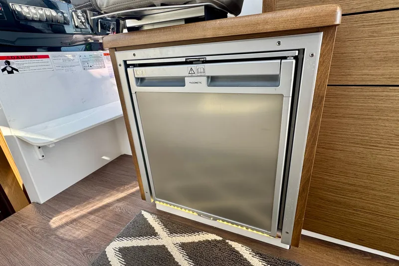 Shanty Town Yacht Photos Pics Compact kitchen area in 2020 Jeanneau NC 895 boat with built-in Dometic fridge.