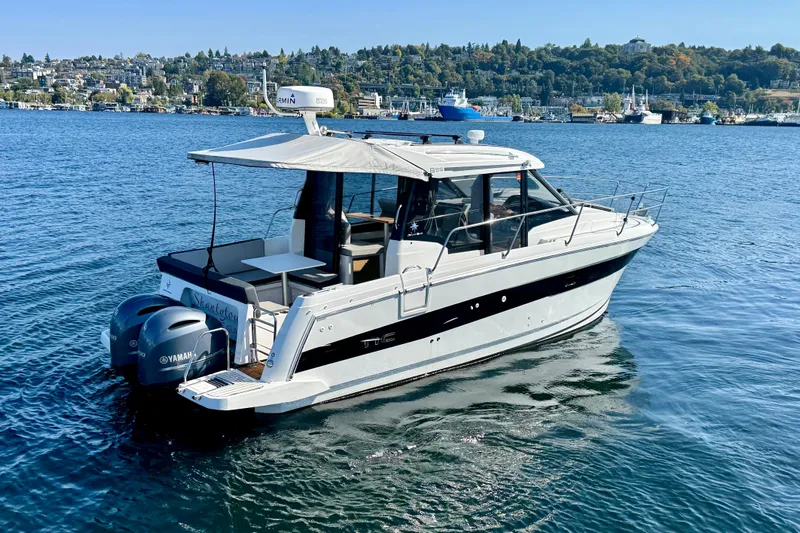 Shanty Town Yacht Photos Pics 2020 Jeanneau NC 895 boat on water, featuring Yamaha engines, scenic shoreline background.