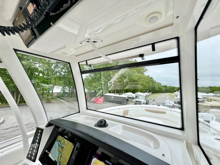  Yacht Photos Pics 2018 Robalo R302 Center Console boat interior with navigation screens and windshield view.