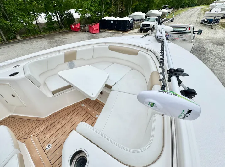  Yacht Photos Pics 2018 Robalo R302 Center Console boat with seating and table, docked outdoors.