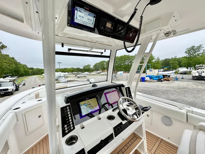  Yacht Photos Pics 2018 Robalo R302 Center Console boat interior with advanced navigation system and steering wheel.