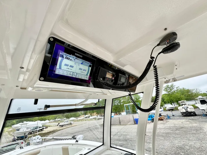  Yacht Photos Pics 2018 Robalo R302 Center Console boat dashboard with Simrad electronics and radio equipment.