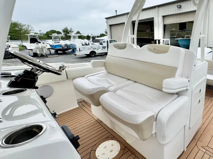  Yacht Photos Pics 2018 Robalo R302 Center Console boat interior with white seating and steering wheel.