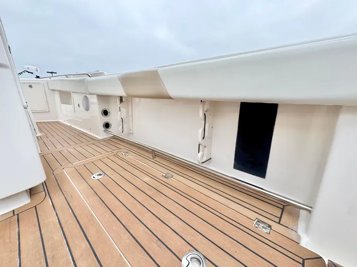  Yacht Photos Pics 2018 Robalo R302 Center Console boat deck with teak flooring and white interior.