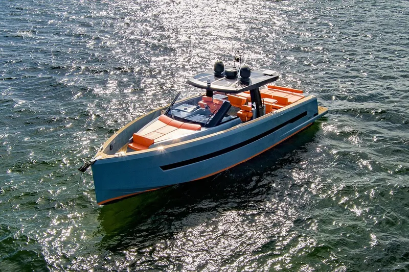 One Love Yacht Photos Pics 2019 Fjord 52 Open yacht on sparkling water, featuring sleek design and vibrant orange seating.