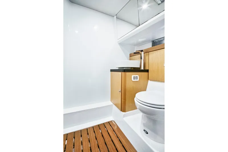 One Love Yacht Photos Pics Modern bathroom interior on 2019 Fjord 52 Open yacht with wooden accents and sleek fixtures.