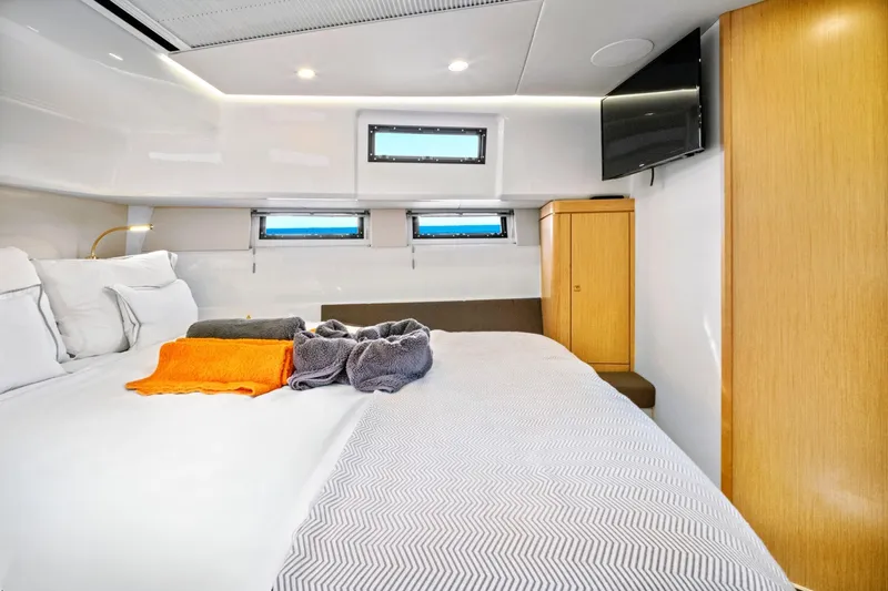 One Love Yacht Photos Pics Luxurious cabin interior of 2019 Fjord 52 Open yacht with cozy bedding and modern amenities.