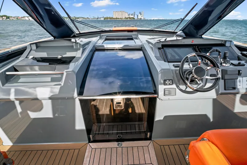One Love Yacht Photos Pics Cockpit of 2019 Fjord 52 Open yacht with modern controls and ocean view.