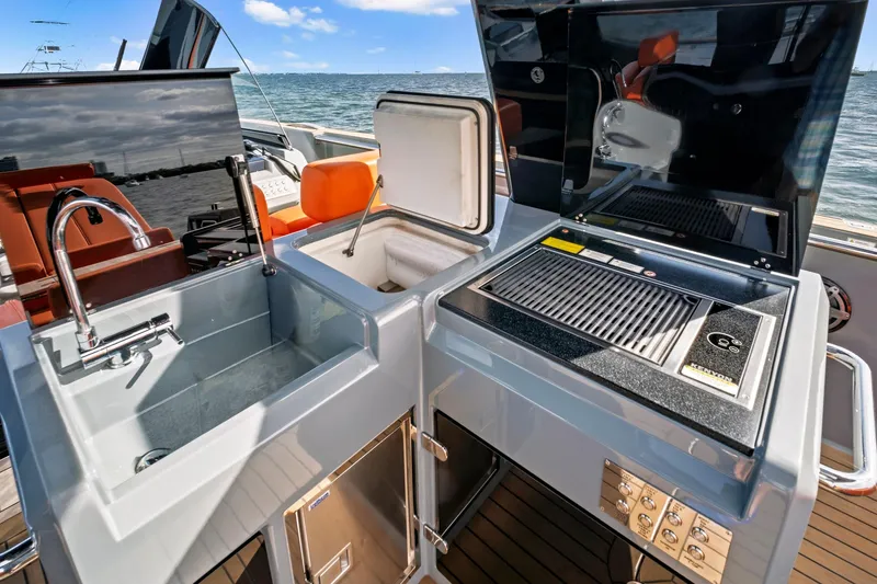 One Love Yacht Photos Pics Outdoor kitchen on 2019 Fjord 52 Open yacht with sink, grill, and storage.