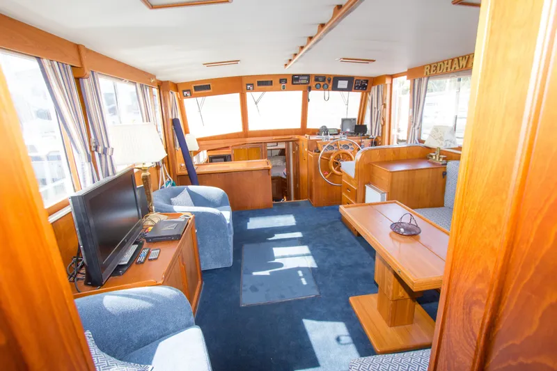 Redhawk Yacht Photos Pics Interior of 1996 Grand Banks 46 Classic yacht with wooden furnishings and blue carpet.