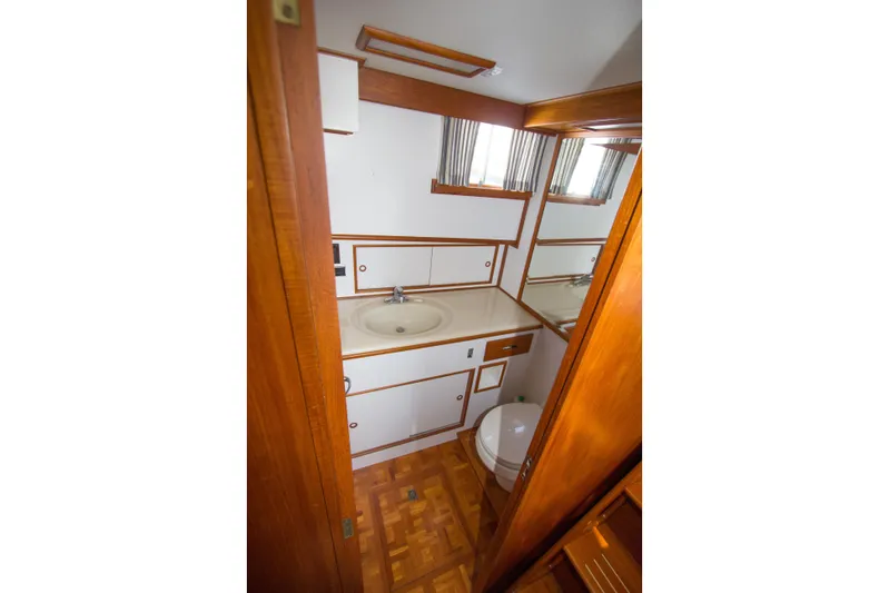 Redhawk Yacht Photos Pics Bathroom interior of 1996 Grand Banks 46 Classic yacht, featuring wood accents and compact design.
