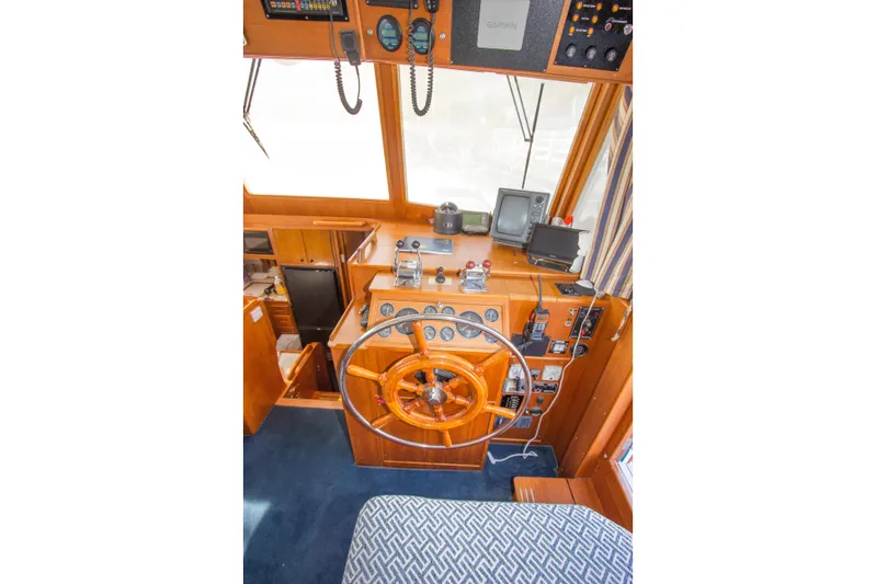 Redhawk Yacht Photos Pics Helm of 1996 Grand Banks 46 Classic yacht with wooden steering wheel and navigation equipment.