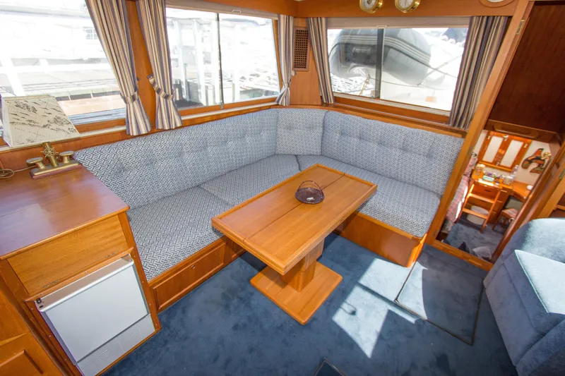 Redhawk Yacht Photos Pics Interior of 1996 Grand Banks 46 Classic yacht with cozy seating and wooden table.
