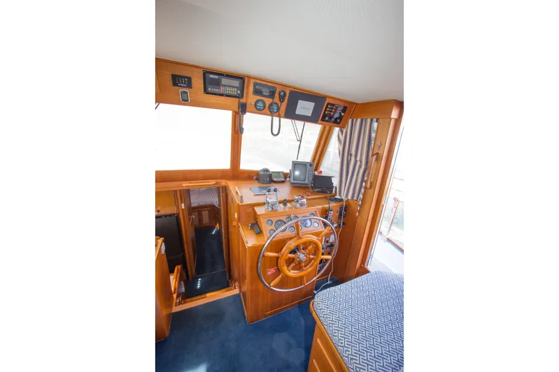 Redhawk Yacht Photos Pics 1996 Grand Banks 46 Classic yacht helm with wooden steering wheel and navigation instruments.
