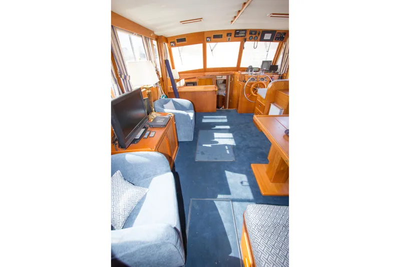 Redhawk Yacht Photos Pics Interior of 1996 Grand Banks 46 Classic yacht with blue carpet and wooden furnishings.