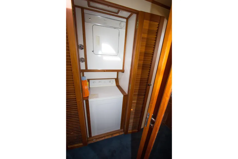 Redhawk Yacht Photos Pics Laundry area with stacked washer and dryer in 1996 Grand Banks 46 Classic yacht.