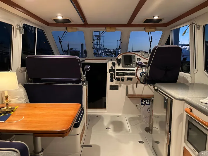  Yacht Photos Pics Interior of 2004 True North 38 boat with helm, seating, and dining area.