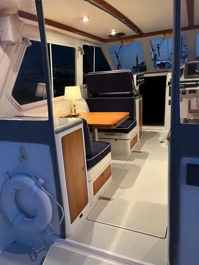  Yacht Photos Pics Interior of a 2004 True North 38 boat with seating and table.