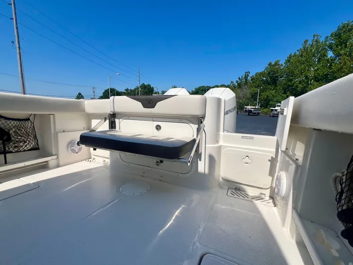  Yacht Photos Pics 2023 Sailfish 290 CC boat interior with seating and storage, under clear blue sky.