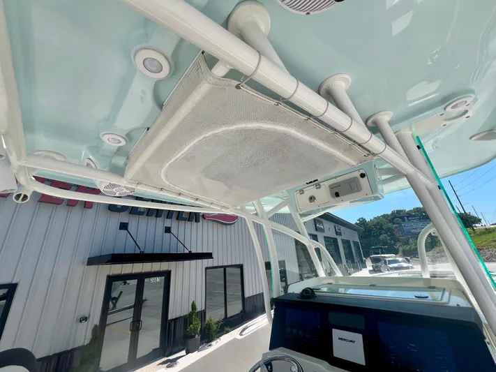  Yacht Photos Pics 2023 Sailfish 290 CC boat interior with electronics and overhead storage.