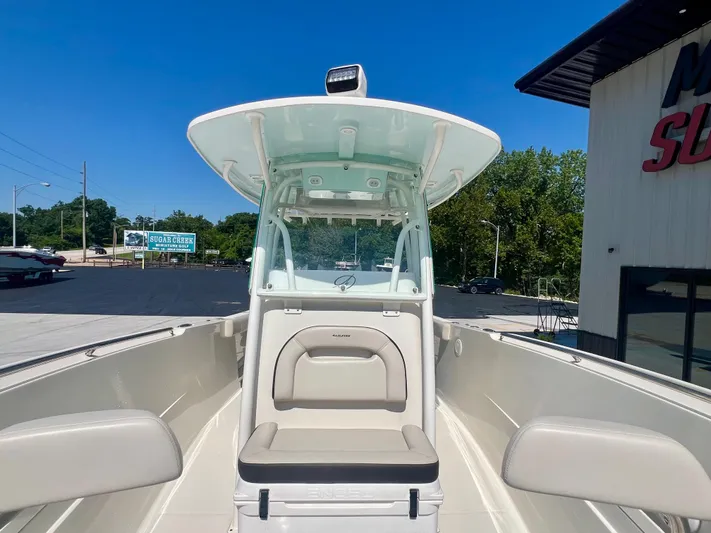  Yacht Photos Pics 2023 Sailfish 290 CC boat with seating, docked outdoors under clear blue sky.