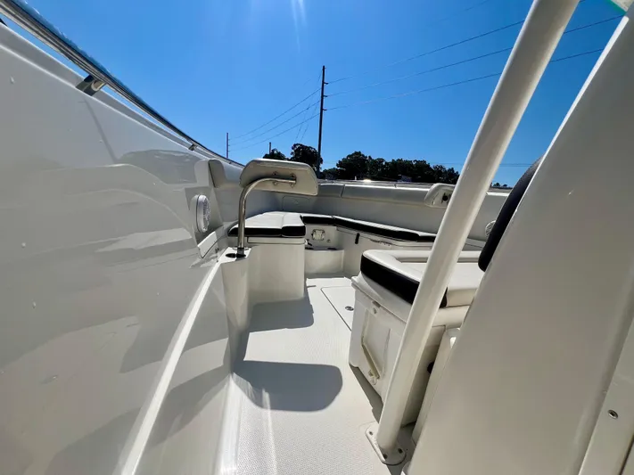  Yacht Photos Pics 2023 Sailfish 290 CC boat interior with seating and storage under clear blue sky.