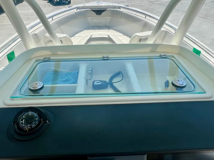  Yacht Photos Pics 2023 Sailfish 290 CC boat dashboard with compass and storage compartment.