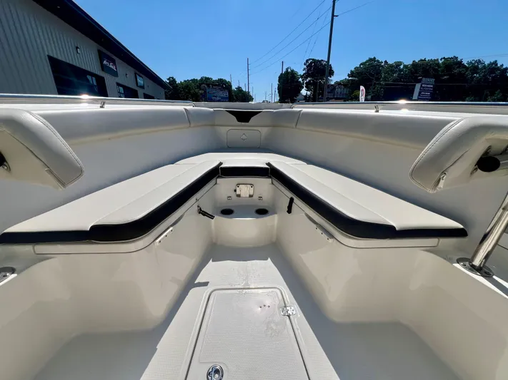  Yacht Photos Pics 2023 Sailfish 290 CC boat interior with cushioned seating and storage compartments.