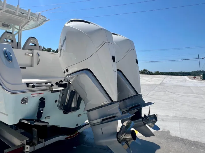  Yacht Photos Pics 2023 Sailfish 290 CC boat with dual outboard engines on a trailer.