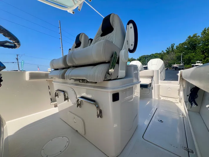  Yacht Photos Pics 2023 Sailfish 290 CC boat interior with cushioned seating and storage compartments.