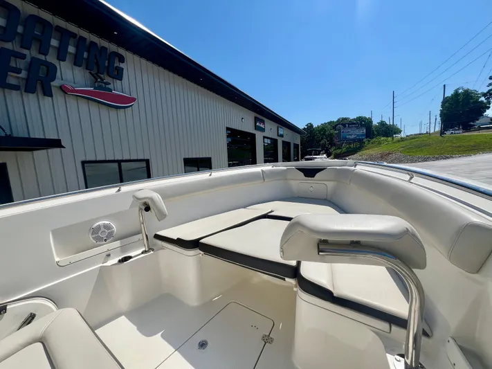  Yacht Photos Pics 2023 Sailfish 290 CC boat interior at a dealership under clear blue sky.