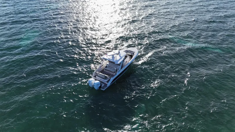  Yacht Photos Pics 2023 Tiara Yachts 34 LS cruising on open water, aerial view.