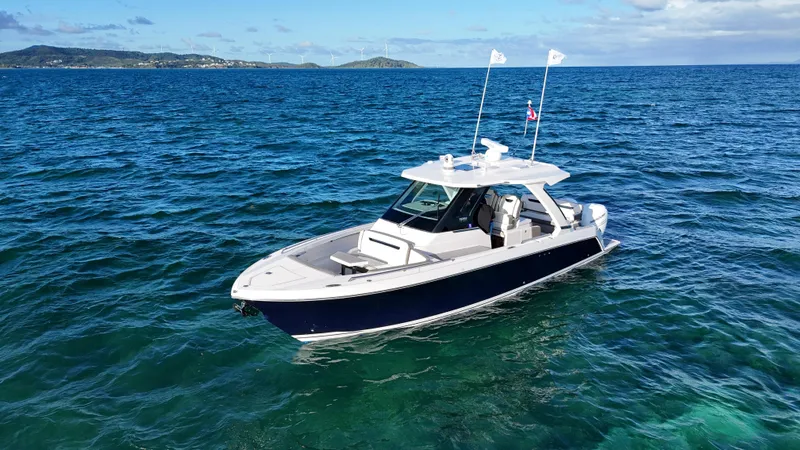  Yacht Photos Pics 2023 Tiara Yachts 34 LS cruising on clear blue ocean waters.