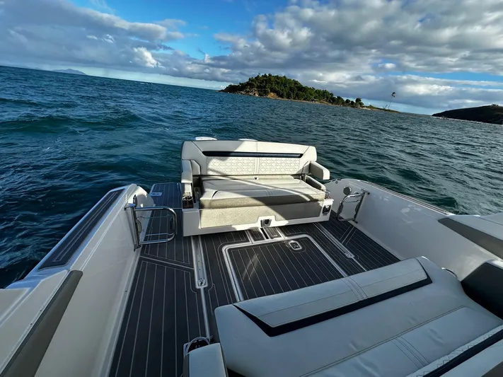  Yacht Photos Pics 2023 Tiara Yachts 34 LS on open water, featuring luxurious seating and scenic ocean view.