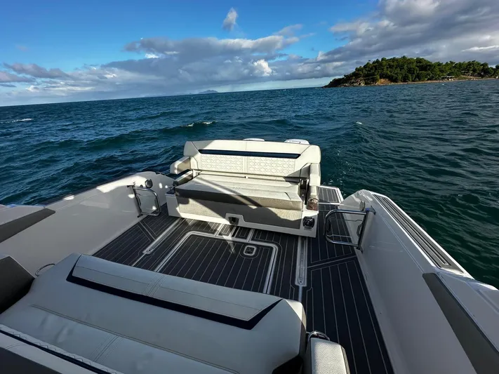  Yacht Photos Pics 2023 Tiara Yachts 34 LS on open sea with island view, featuring spacious deck seating.