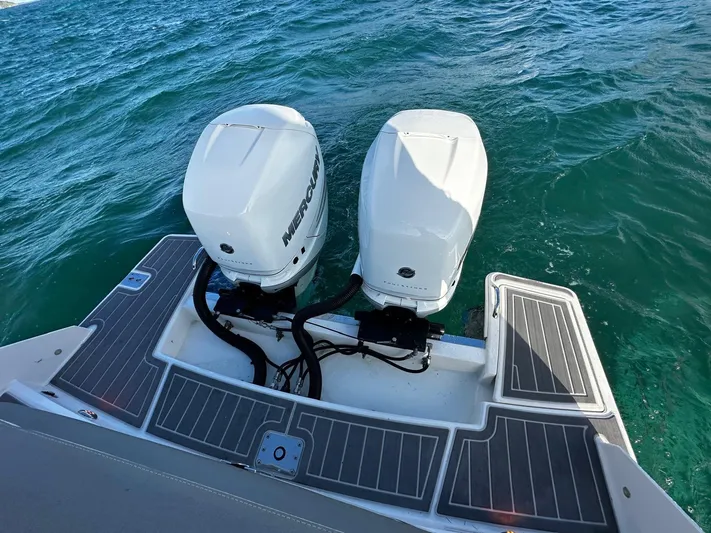  Yacht Photos Pics 2023 Tiara Yachts 34 LS with dual Mercury outboard engines on blue water.