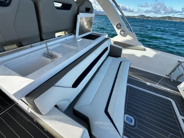  Yacht Photos Pics 2023 Tiara Yachts 34 LS interior with seating, sink, and ocean view.