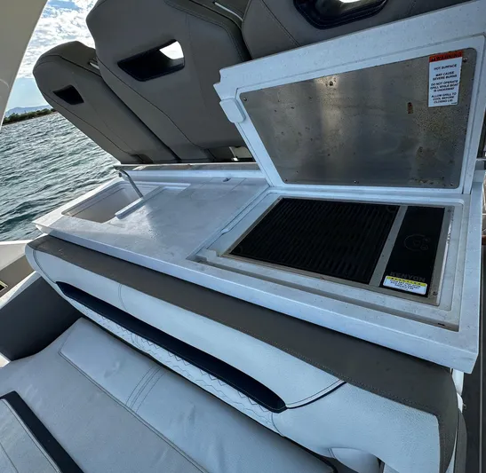  Yacht Photos Pics 2023 Tiara Yachts 34 LS boat with open grill on deck, near water.