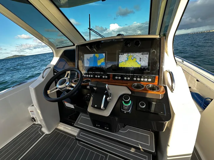  Yacht Photos Pics 2023 Tiara Yachts 34 LS helm with dual navigation screens and sleek design on open water.