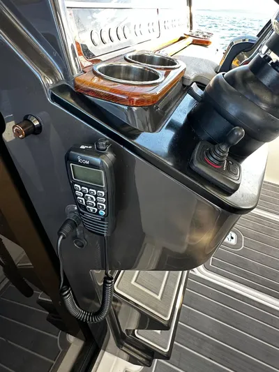  Yacht Photos Pics 2023 Tiara Yachts 34 LS helm with radio and cup holders.