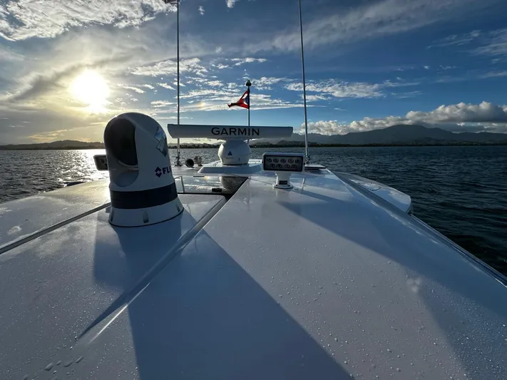  Yacht Photos Pics 2023 Tiara Yachts 34 LS on water at sunset, featuring Garmin equipment.