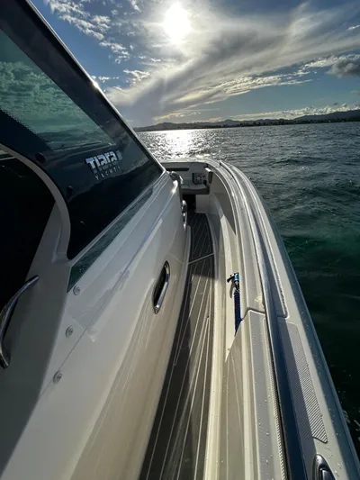  Yacht Photos Pics 2023 Tiara Yachts 34 LS on water, sunlit sky reflecting on ocean.