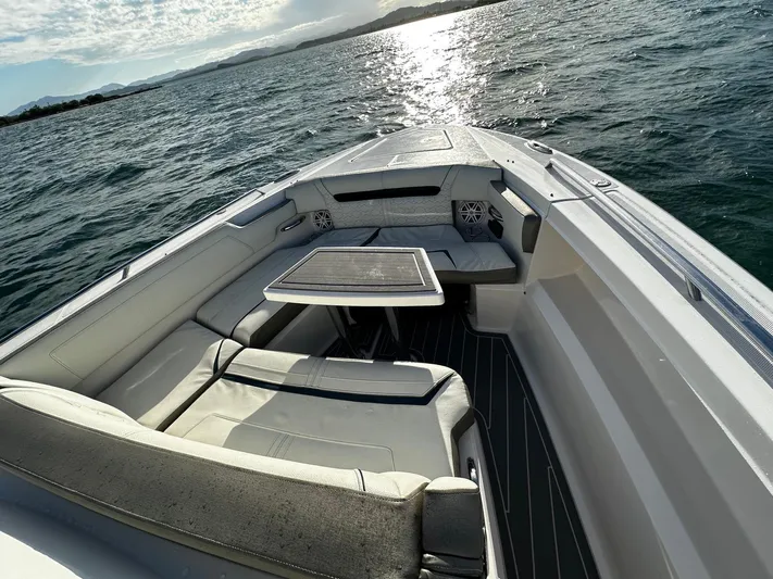  Yacht Photos Pics 2023 Tiara Yachts 34 LS boat interior with seating and table on open water.