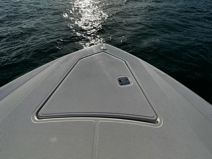  Yacht Photos Pics 2023 Tiara Yachts 34 LS bow, textured deck, sunlight reflecting on water.