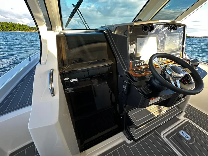  Yacht Photos Pics 2023 Tiara Yachts 34 LS helm with modern controls and scenic water view.