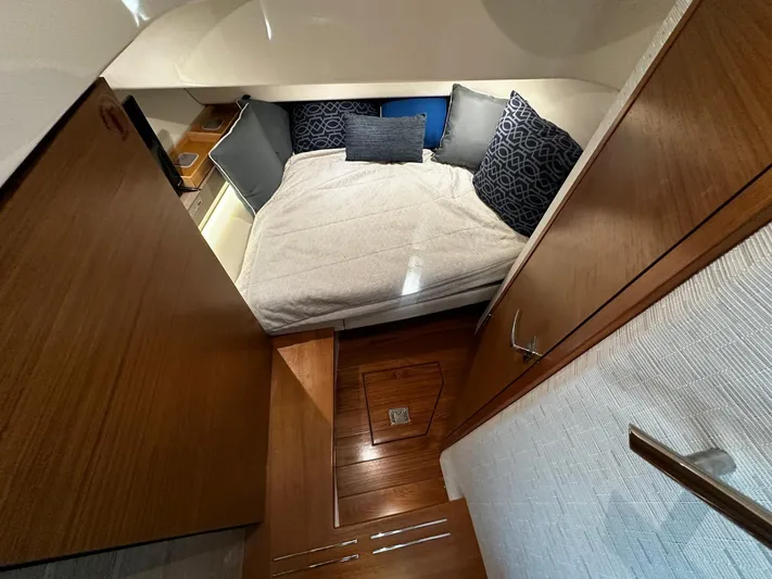  Yacht Photos Pics 2023 Tiara Yachts 34 LS cabin interior with cozy bed and wooden finish.