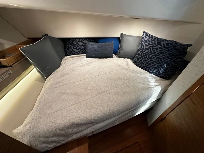  Yacht Photos Pics 2023 Tiara Yachts 34 LS cabin with cozy bedding and decorative pillows.