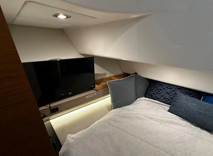  Yacht Photos Pics 2023 Tiara Yachts 34 LS cabin interior with bed, TV, and cushions.